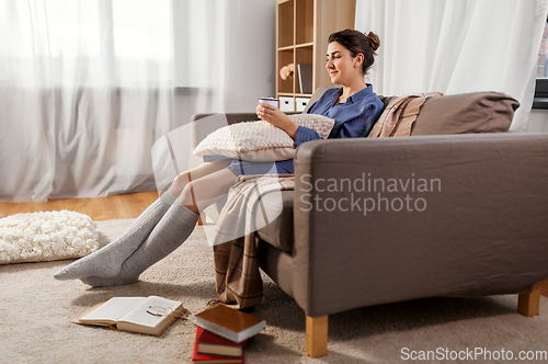 Image of woman drinking hot chocolate at home