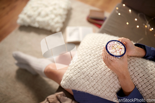 Image of woman drinking hot chocolate at home