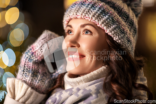 Image of happy woman calling on smartphone on christmas