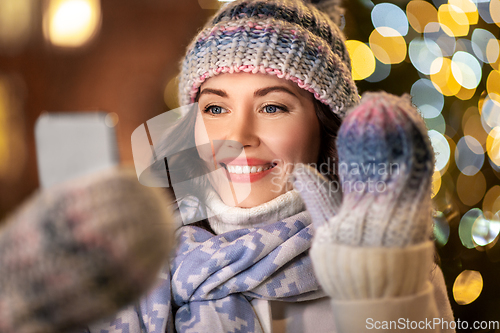 Image of woman with phone having video call on christmas