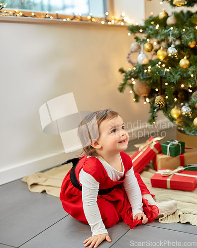 Image of happy baby girl with christmas gifts at home