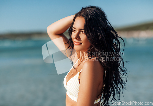 Image of beautiful young woman in bikini swimsuit on beach