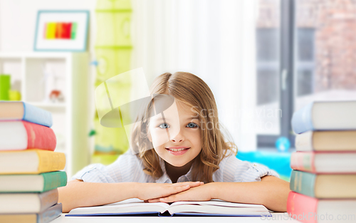 Image of smiling student girl with books learning at home