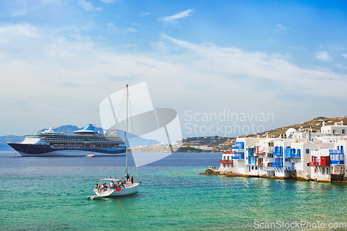 Image of Little Venice houses in Chora Mykonos town with yacht and cruise ship. Mykonos island, Greecer