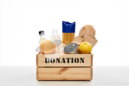 Image of food donation in wooden box on table
