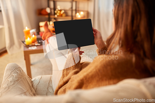 Image of woman with tablet pc at home on halloween