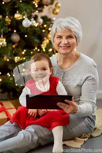 Image of grandmother and baby girl with christmas gifts