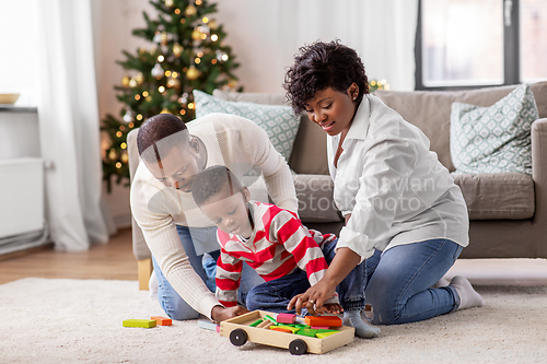 Image of african family with toys on christmas at home