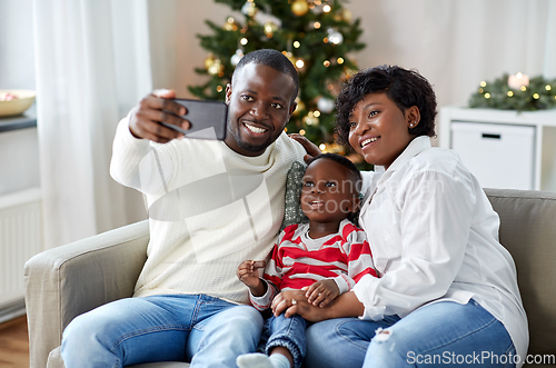 Image of african family taking selfie on christmas at home