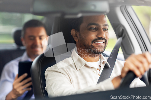 Image of indian male driver driving car with passenger