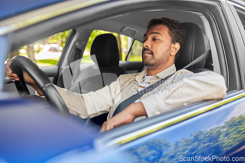 Image of indian man or driver driving car