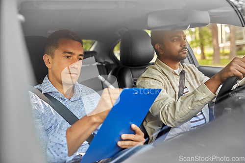 Image of car driving school instructor and young driver