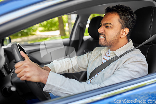 Image of angry indian man or driver driving car