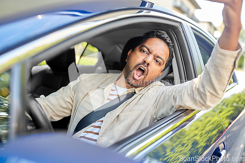 Image of angry indian man or driver driving car