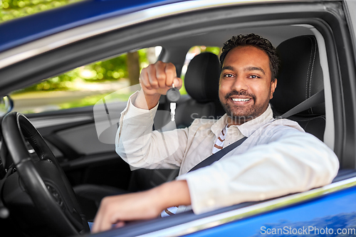 Image of smiling indian man or driver showing car key