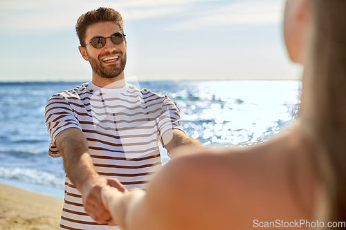 Image of happy couple having fun on summer beach