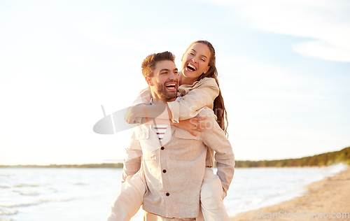 Image of happy couple having fun on summer beach