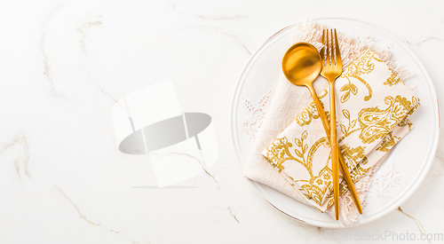 Image of Festive place setting for Christmas or New Year in golden tone