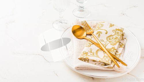 Image of Festive place setting for Christmas or New Year in golden tone