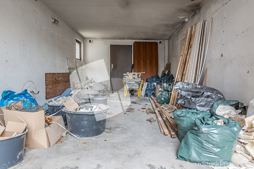 Image of Renovation of old house, garage with rubble under construction