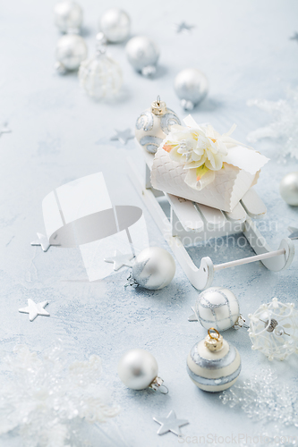 Image of Christmas ornaments, balls and small present box on sledge