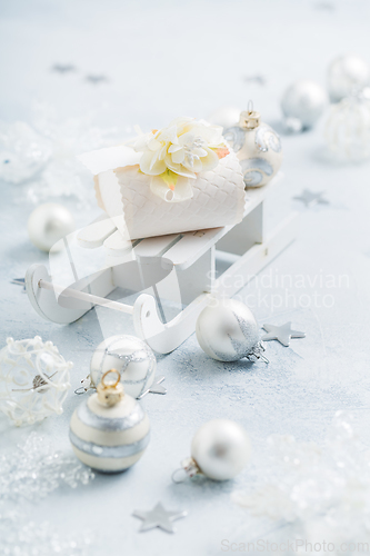 Image of Christmas ornaments, balls and small present box on sledge