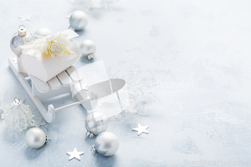 Image of Christmas ornaments, balls and small present box on sledge