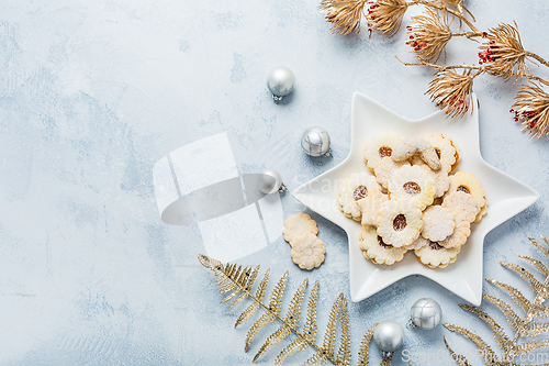 Image of Homemade Christmas cookies and ornaments on kitchen table