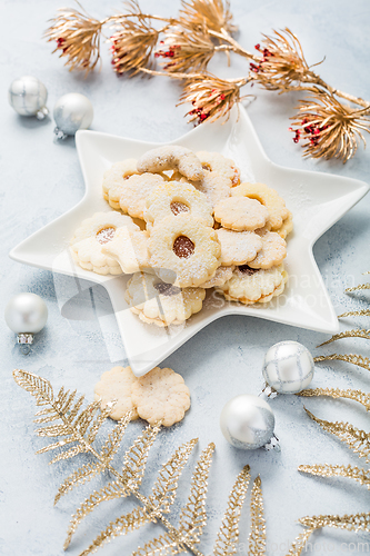 Image of Homemade Christmas cookies and ornaments on kitchen table