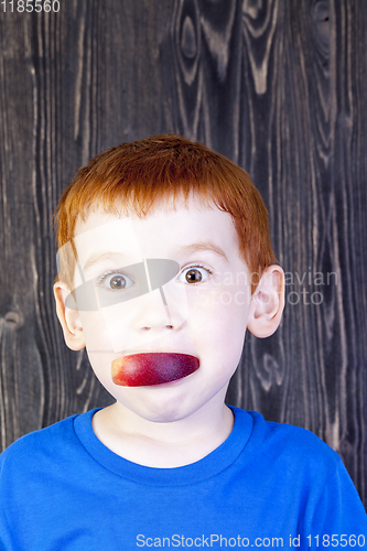 Image of red-haired boy eats