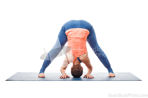 Image of Woman doing yoga asana Prasarita padottanasana