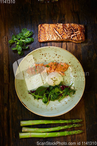 Image of Slow Cooked Salmon fillet steak with salad on plate, Sous-Vide Cooking Salmon Fish