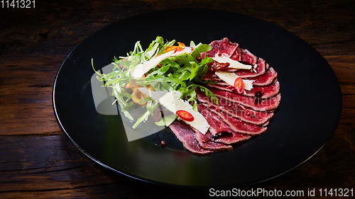 Image of Barbecue wagyu roast beef sliced as top view on a metal tray with copy space right