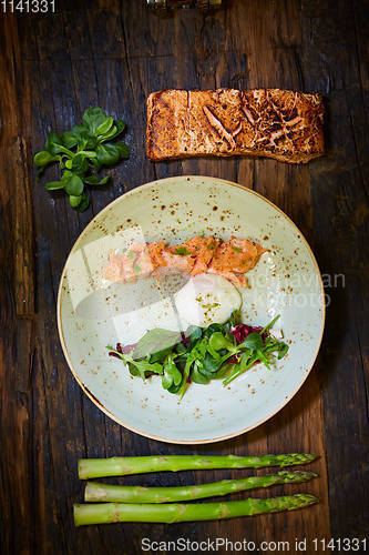 Image of Slow Cooked Salmon fillet steak with salad on plate, Sous-Vide Cooking Salmon Fish