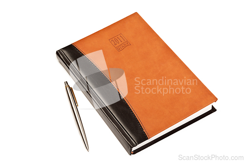 Image of Diary and pen on table isolated