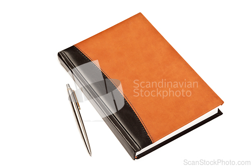 Image of Diary and pen on table isolated