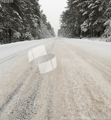 Image of a dirty, broken snow-covered road