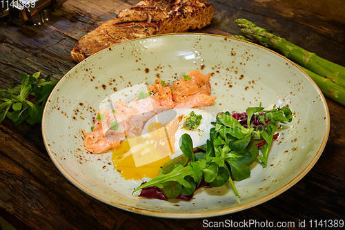 Image of Slow Cooked Salmon fillet steak with salad on plate, Sous-Vide Cooking Salmon Fish