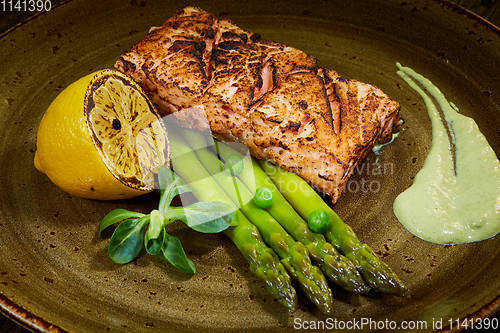 Image of Slow Cooked Salmon fillet steak with salad on plate, Sous-Vide Cooking Salmon Fish