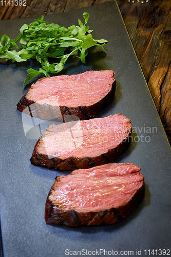 Image of Sous-vide steak cut into pieces, cooked to eat beef on the stone table