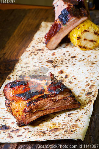 Image of Roasted sliced barbecue pork ribs, focus on sliced meat