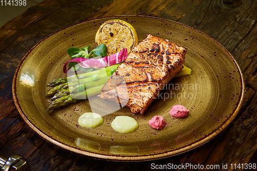 Image of Slow Cooked Salmon fillet steak with salad on plate, Sous-Vide Cooking Salmon Fish