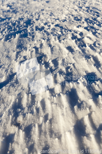 Image of snow-covered soil surface close up ,