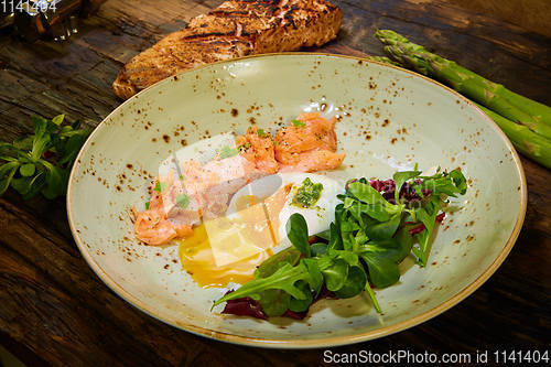 Image of Slow Cooked Salmon fillet steak with salad on plate, Sous-Vide Cooking Salmon Fish