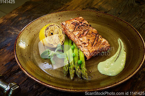 Image of Slow Cooked Salmon fillet steak with salad on plate, Sous-Vide Cooking Salmon Fish