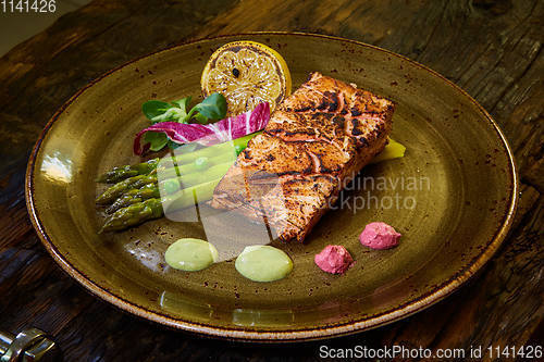 Image of Slow Cooked Salmon fillet steak with salad on plate, Sous-Vide Cooking Salmon Fish