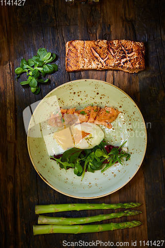 Image of Slow Cooked Salmon fillet steak with salad on plate, Sous-Vide Cooking Salmon Fish