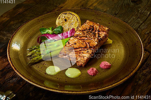 Image of Slow Cooked Salmon fillet steak with salad on plate, Sous-Vide Cooking Salmon Fish