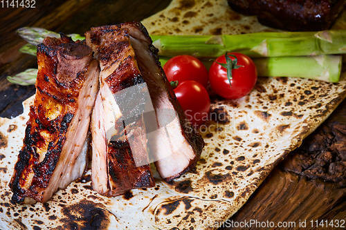 Image of Roasted sliced barbecue pork ribs, focus on sliced meat