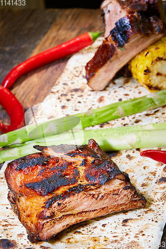 Image of Roasted sliced barbecue pork ribs, focus on sliced meat